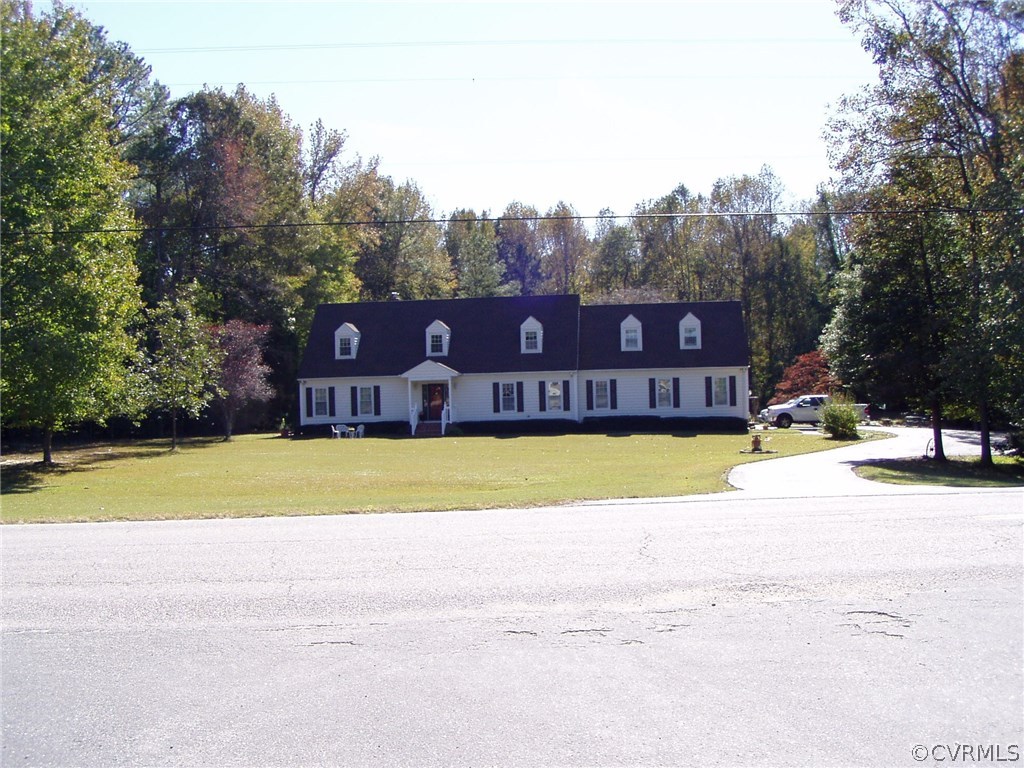 8725 Sandy Ridge Road Hopewell, VA 23860 - Photo 2 of 19 a view of a swimming pool with trees in the background