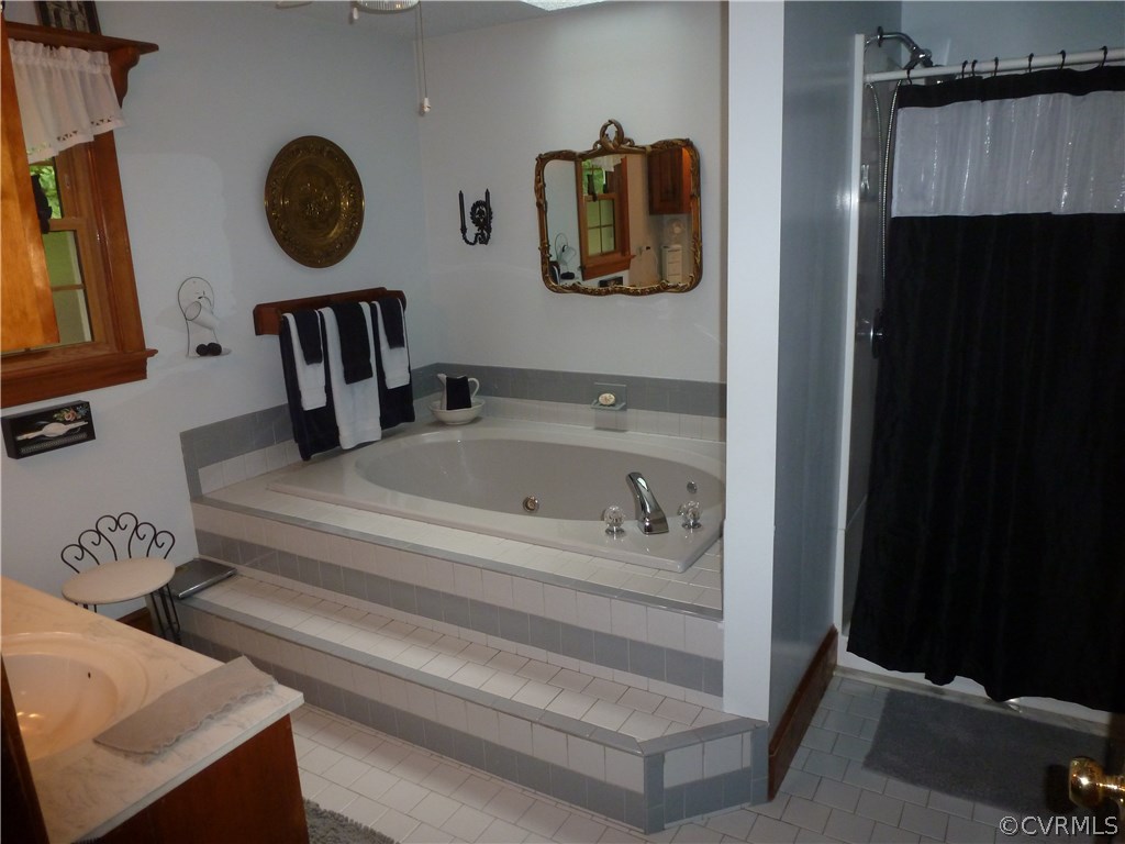 8725 Sandy Ridge Road Hopewell, VA 23860 - Photo 10 of 19 a bathroom with a bathtub and a sink