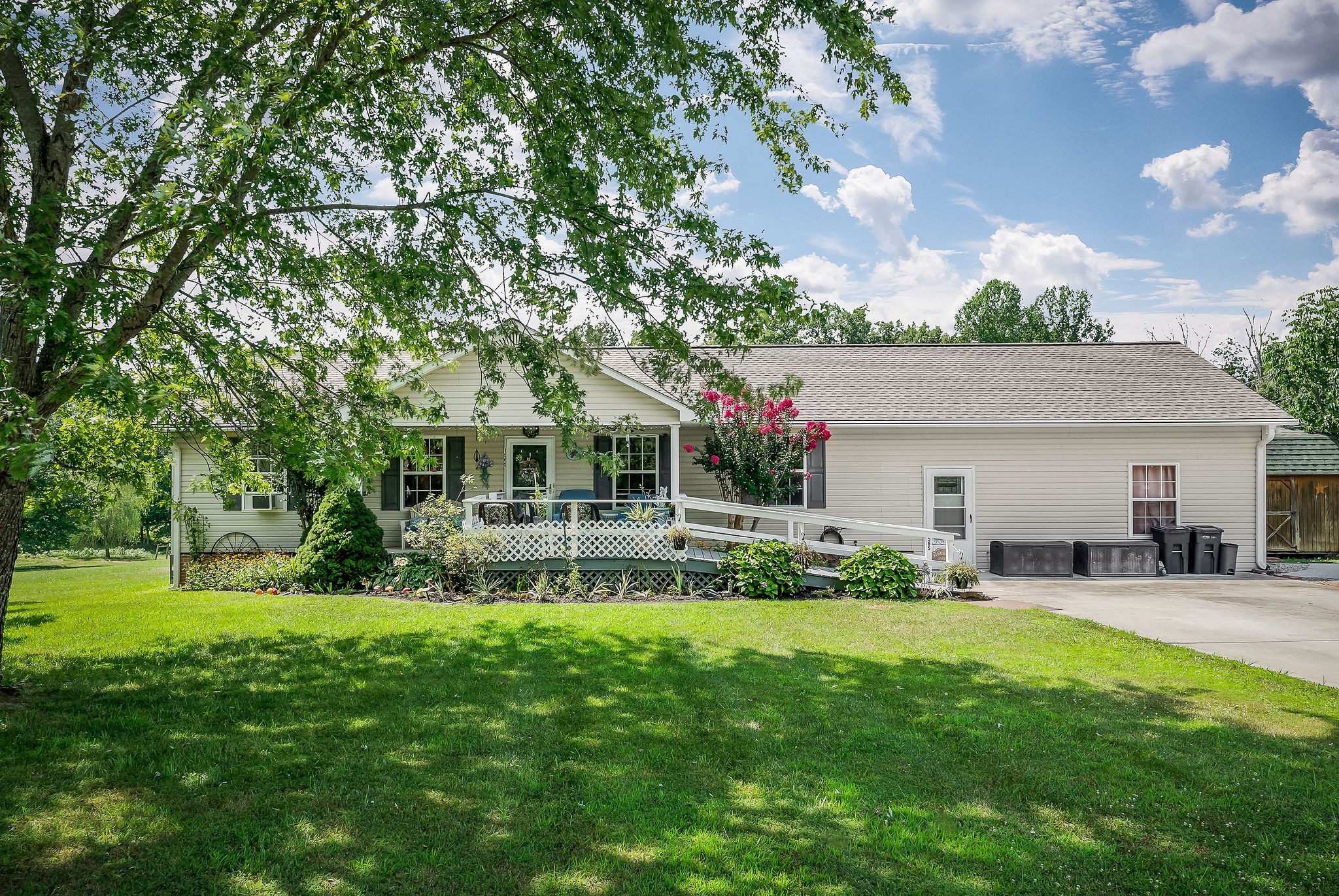 a view of a house with a yard and sitting area