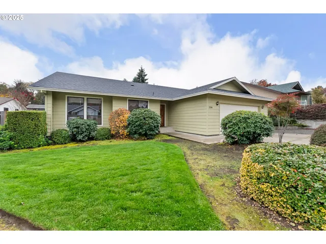 a front view of a house with a garden