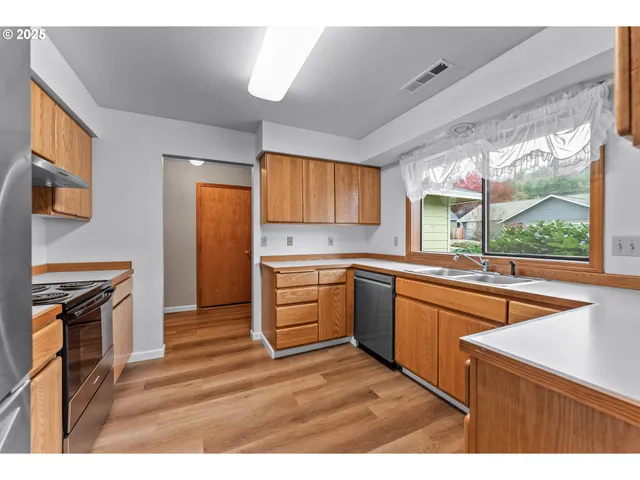a kitchen with granite countertop a refrigerator and a sink