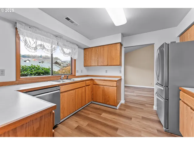 a kitchen with stainless steel appliances granite countertop a refrigerator and a stove