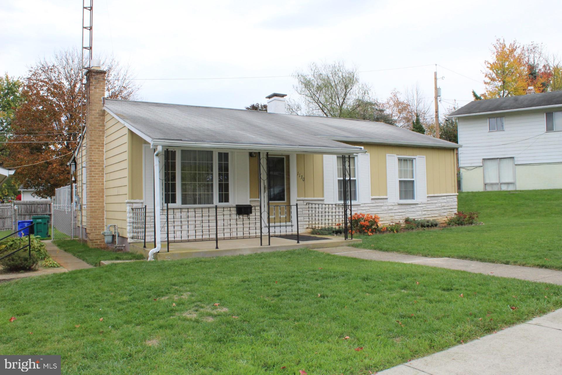 a view of a house with a yard and sitting area