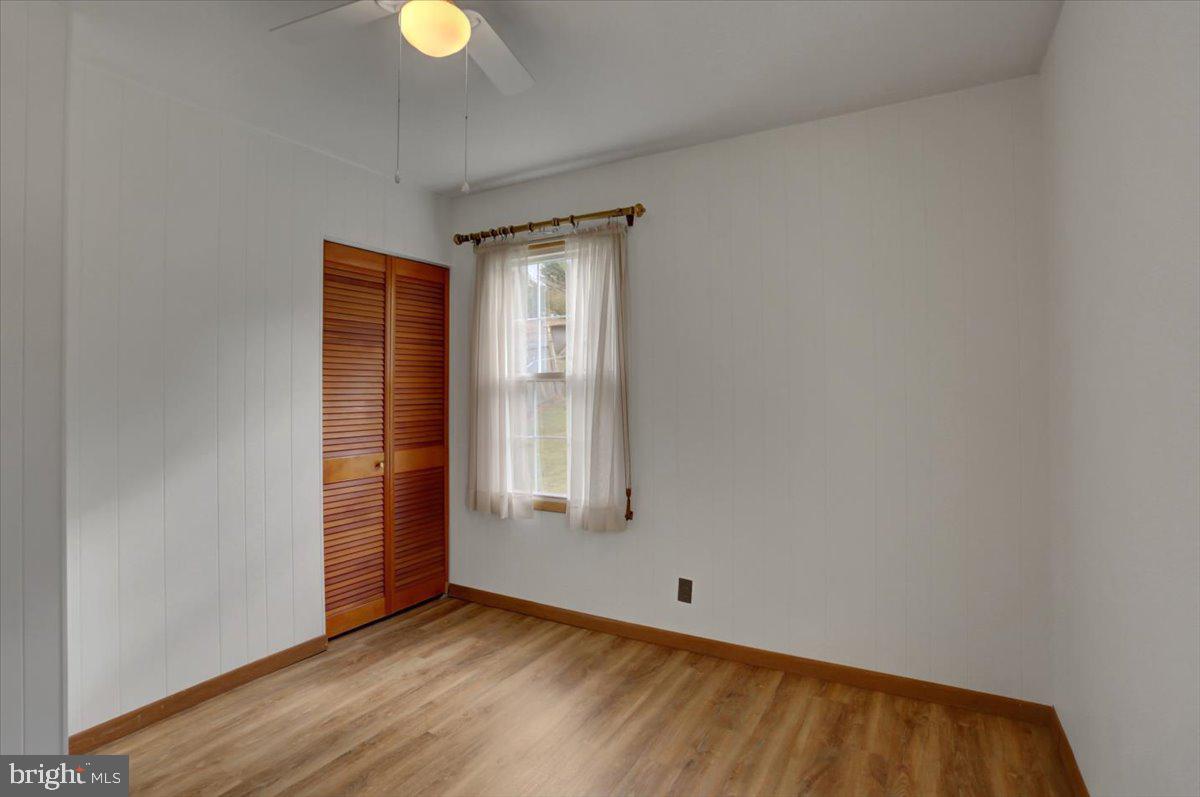 1130 Outer Drive Hagerstown, MD 21742 - Photo 14 of 37 an empty room with wooden floor and windows