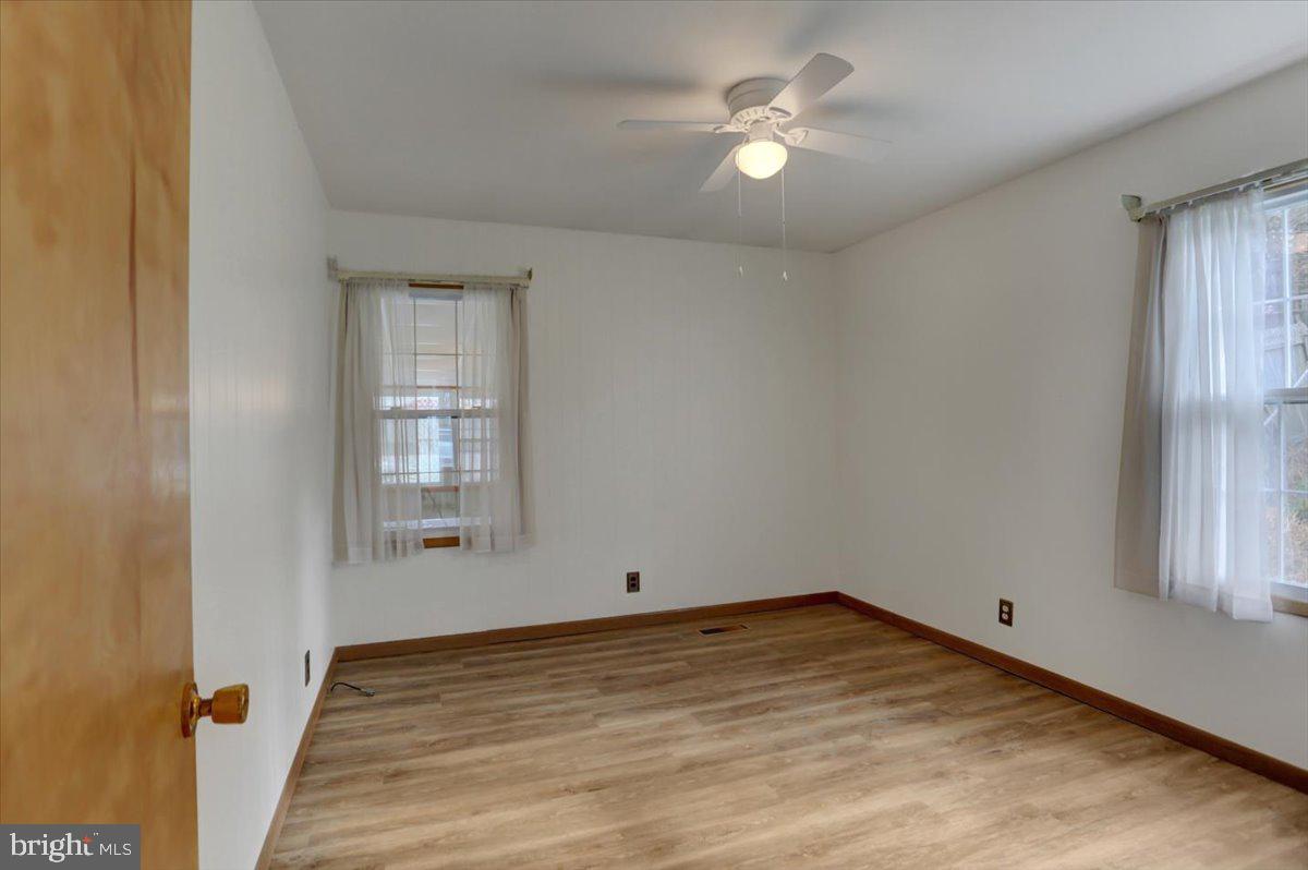 1130 Outer Drive Hagerstown, MD 21742 - Photo 15 of 37 wooden floor in an empty room with a window