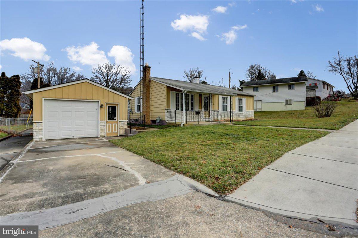 1130 Outer Drive Hagerstown, MD 21742 - Photo 2 of 37 a front view of a house with a garden and yard