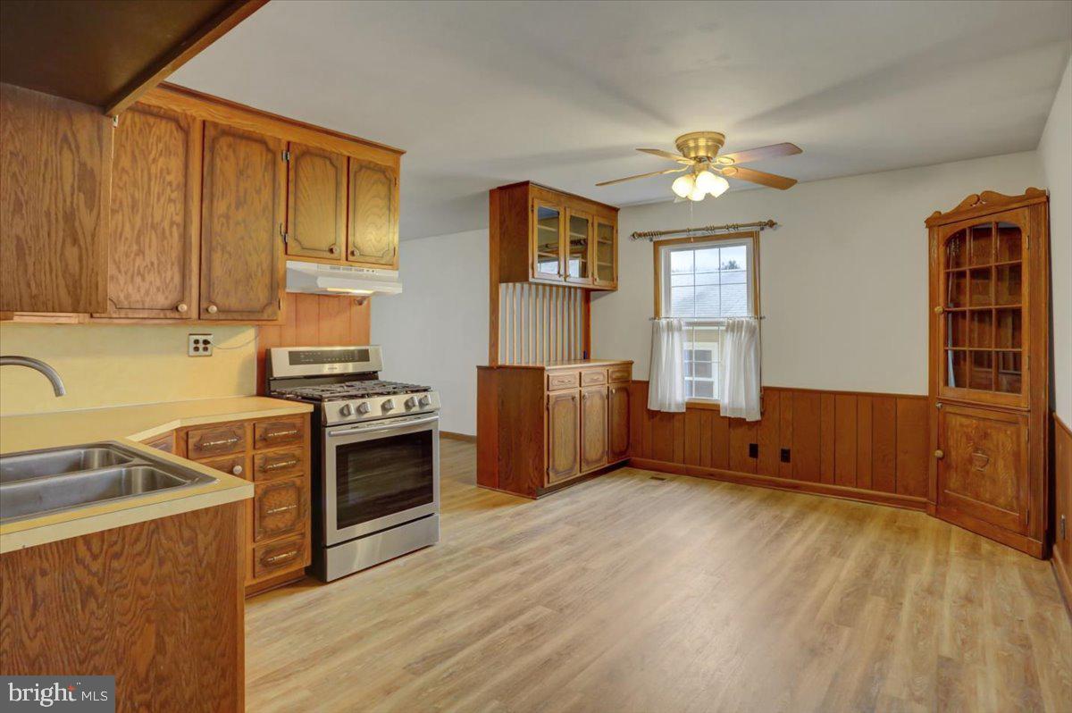 1130 Outer Drive Hagerstown, MD 21742 - Photo 3 of 37 a kitchen with stainless steel appliances granite countertop a stove a sink dishwasher and a refrigerator with wooden floor