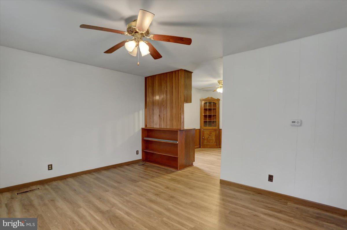 1130 Outer Drive Hagerstown, MD 21742 - Photo 8 of 37 wooden floor in an empty room with a window