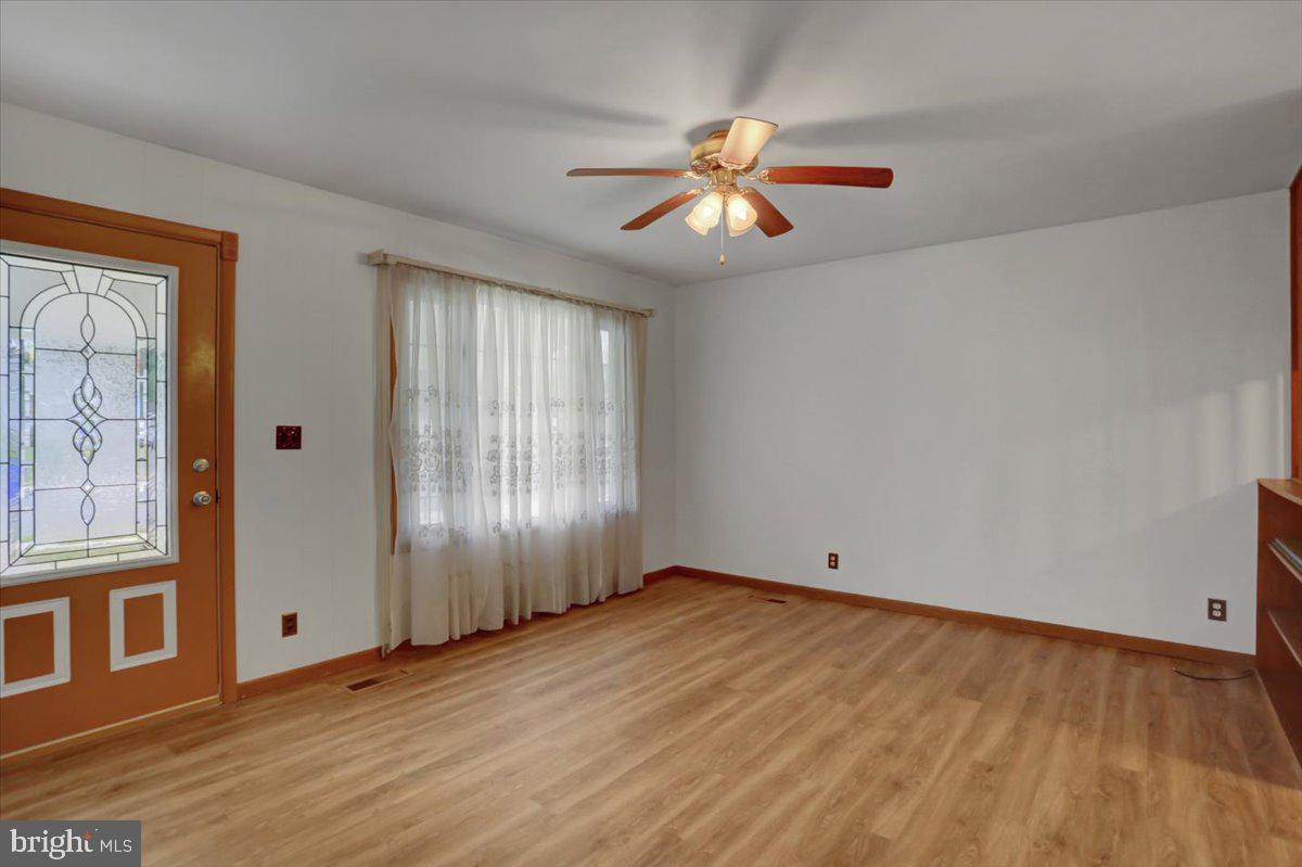 1130 Outer Drive Hagerstown, MD 21742 - Photo 9 of 37 a view of an empty room with wooden floor and a window