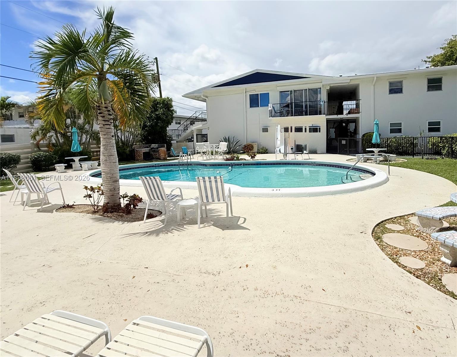 3600 Harrison Street, Unit 16B Hollywood, FL 33021 - Photo 1 of 34 a view of a house with swimming pool and sitting area