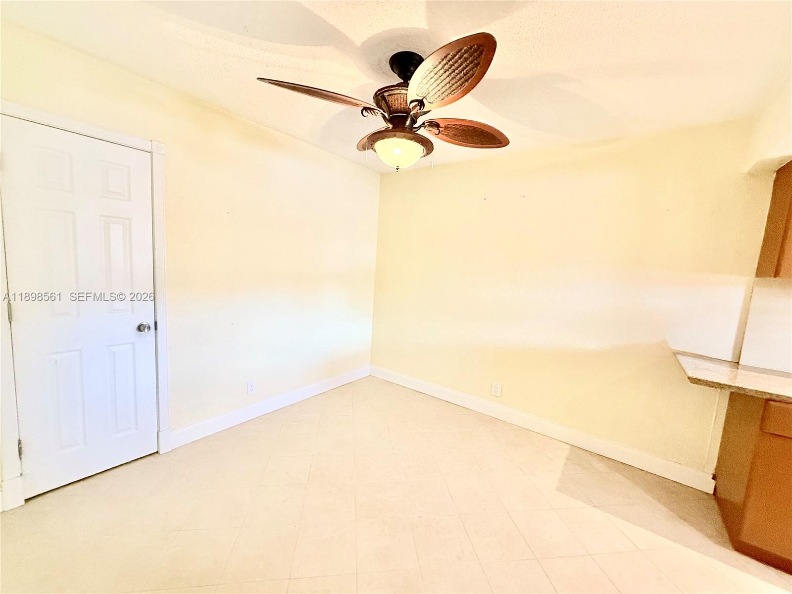 3600 Harrison Street, Unit 16B Hollywood, FL 33021 - Photo 11 of 34 a view of a room with a ceiling fan and wooden floor