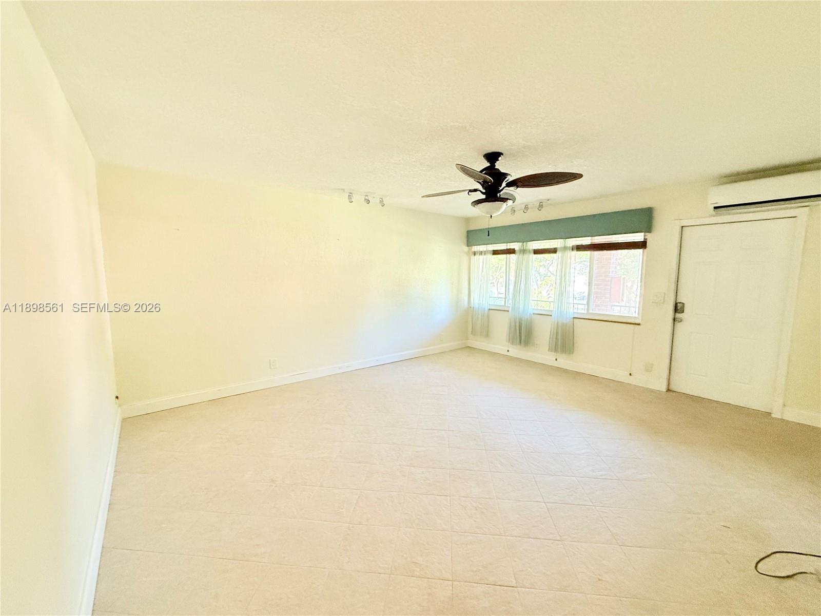3600 Harrison Street, Unit 16B Hollywood, FL 33021 - Photo 15 of 34 an empty room with a ceiling fan and window