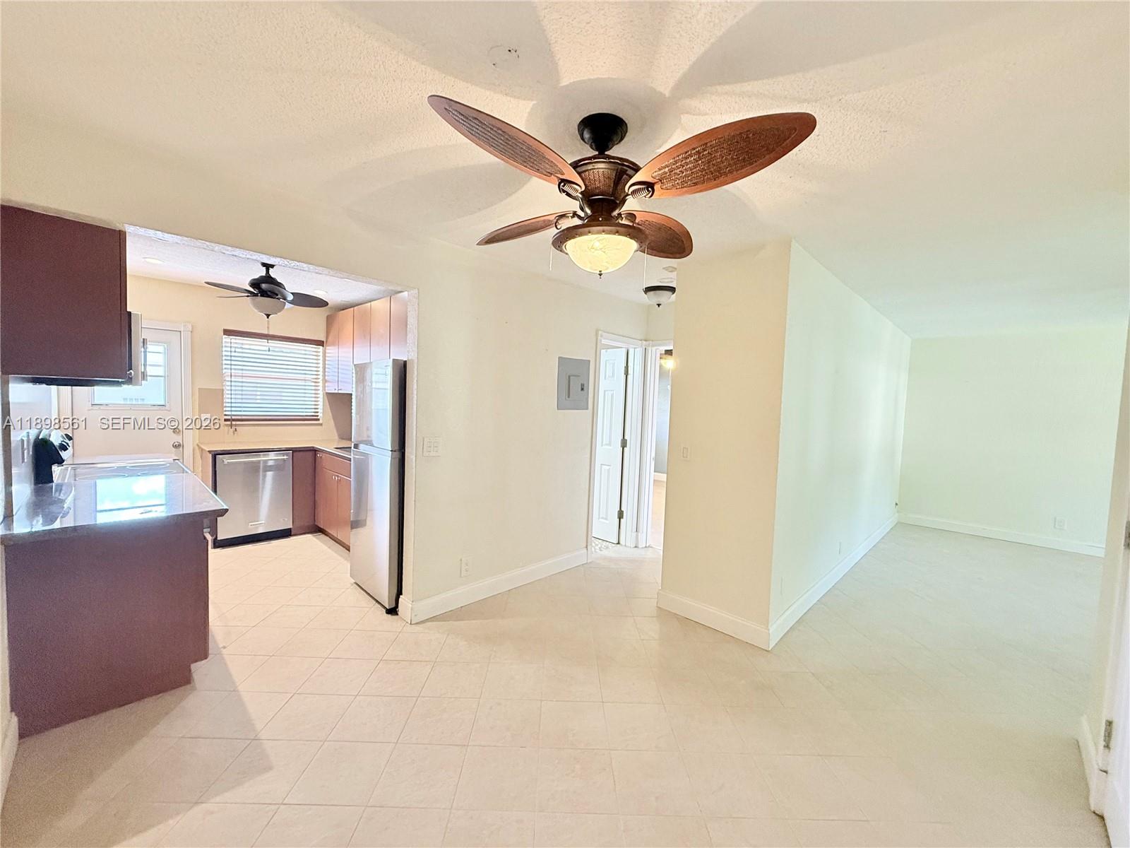 3600 Harrison Street, Unit 16B Hollywood, FL 33021 - Photo 2 of 34 a view of a livingroom with a ceiling fan a ceiling fan and wooden floor