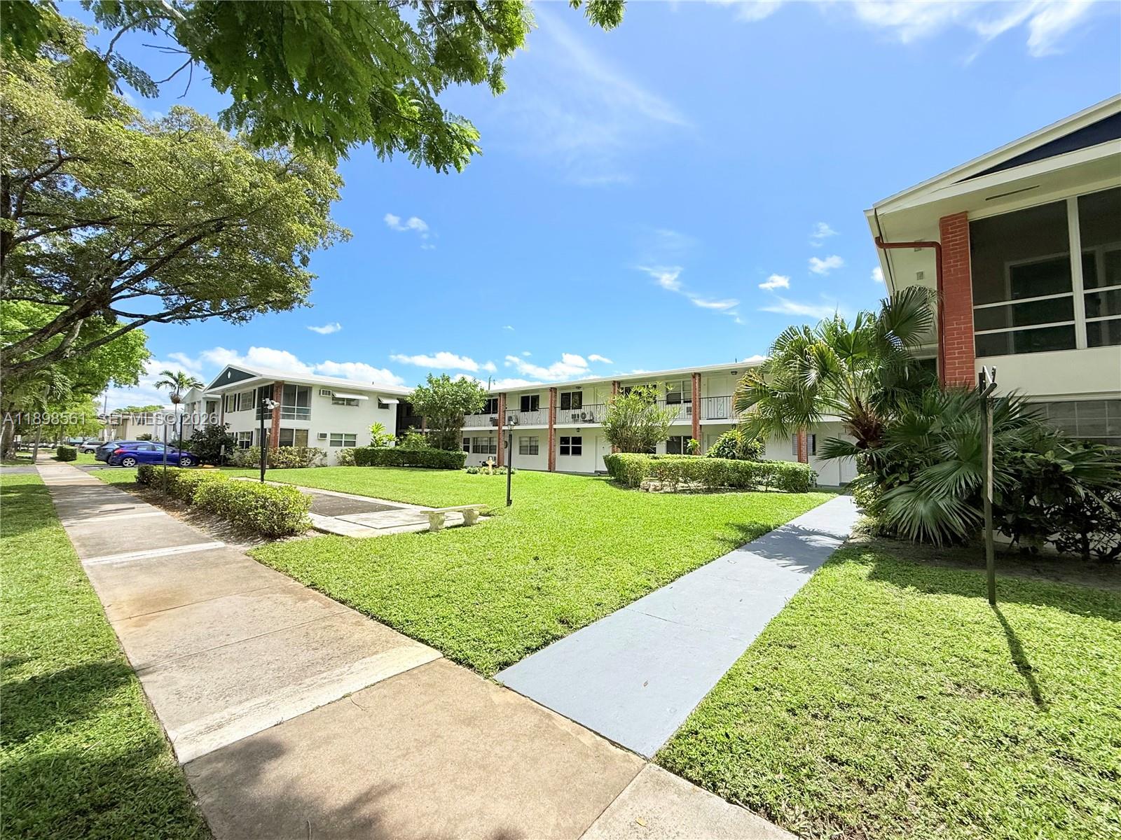 3600 Harrison Street, Unit 16B Hollywood, FL 33021 - Photo 25 of 34 a view of a house with a big yard plants and large trees