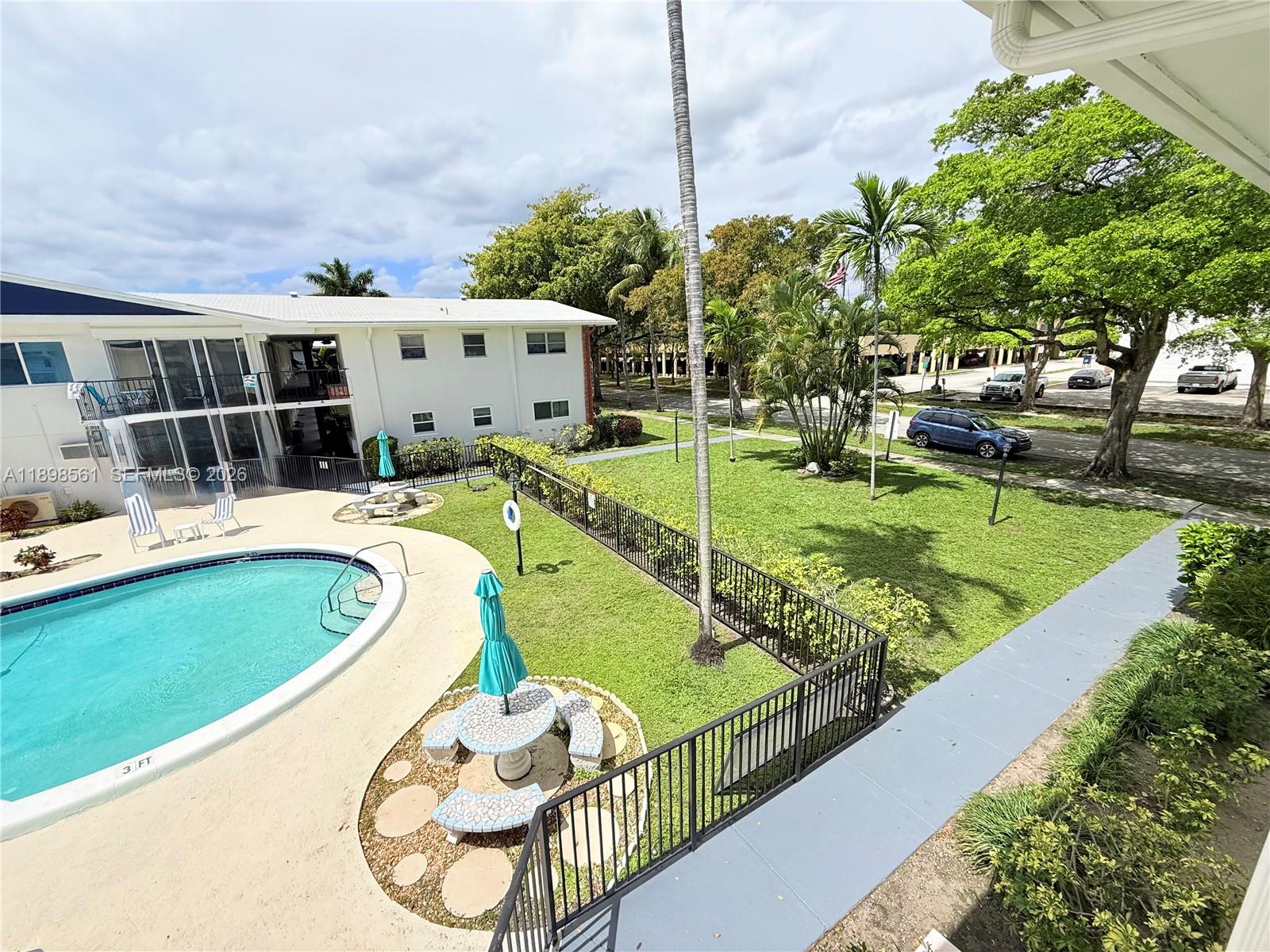 3600 Harrison Street, Unit 16B Hollywood, FL 33021 - Photo 27 of 34 a view of a swimming pool with a patio