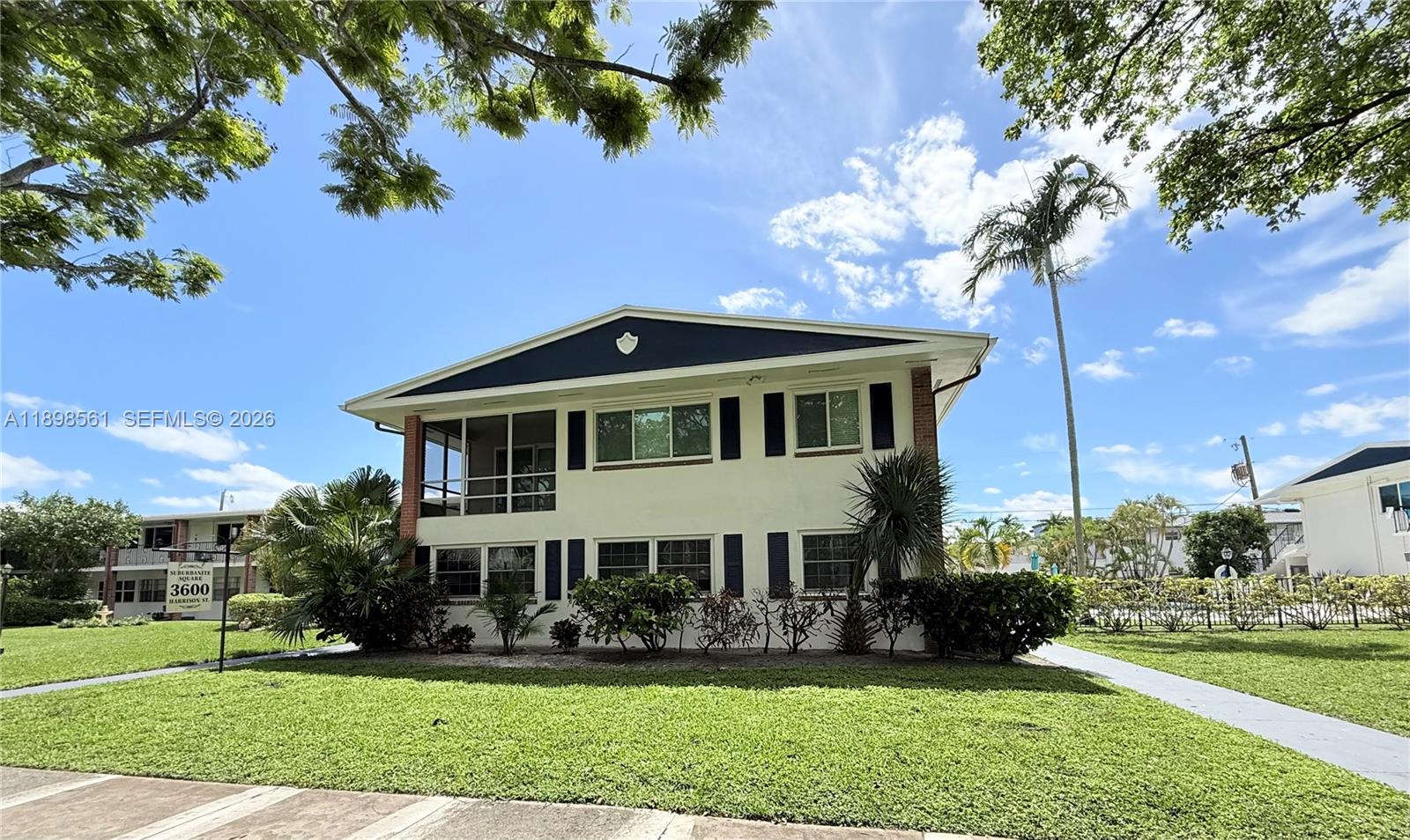 3600 Harrison Street, Unit 16B Hollywood, FL 33021 - Photo 34 of 34 a front view of a house with a yard table and chairs