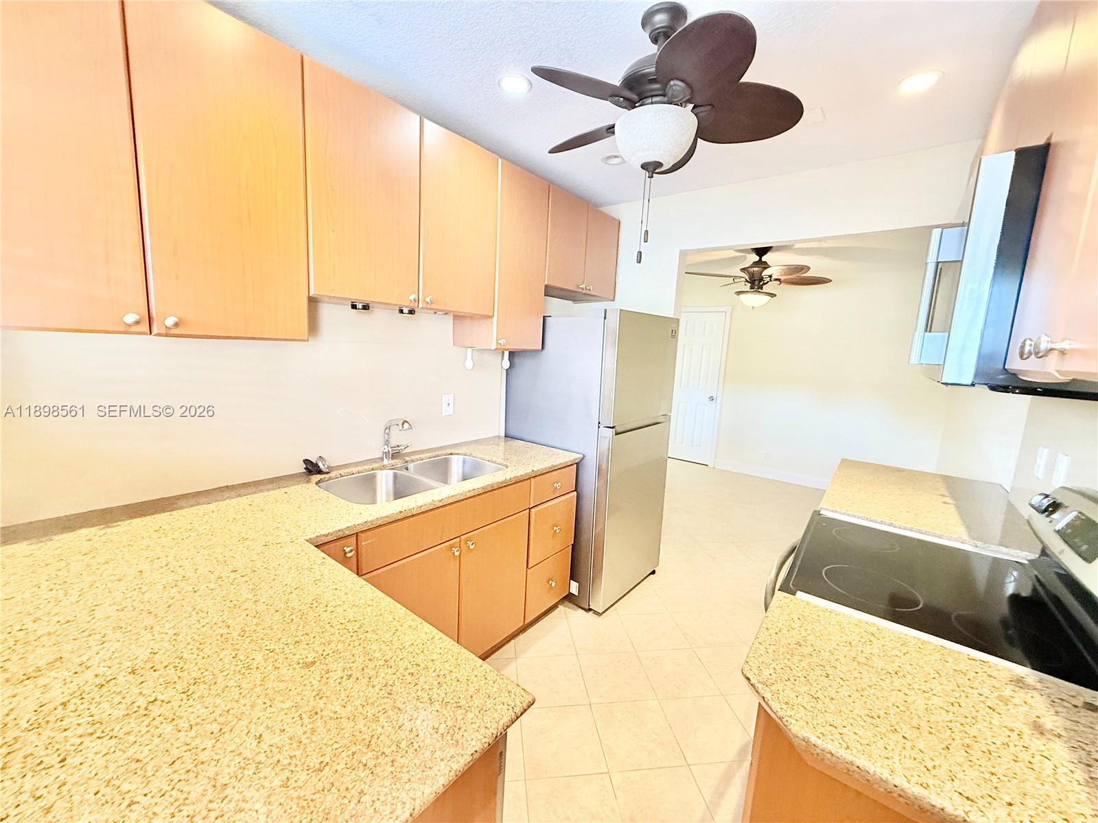3600 Harrison Street, Unit 16B Hollywood, FL 33021 - Photo 4 of 34 a kitchen with stainless steel appliances granite countertop a sink a stove and a refrigerator