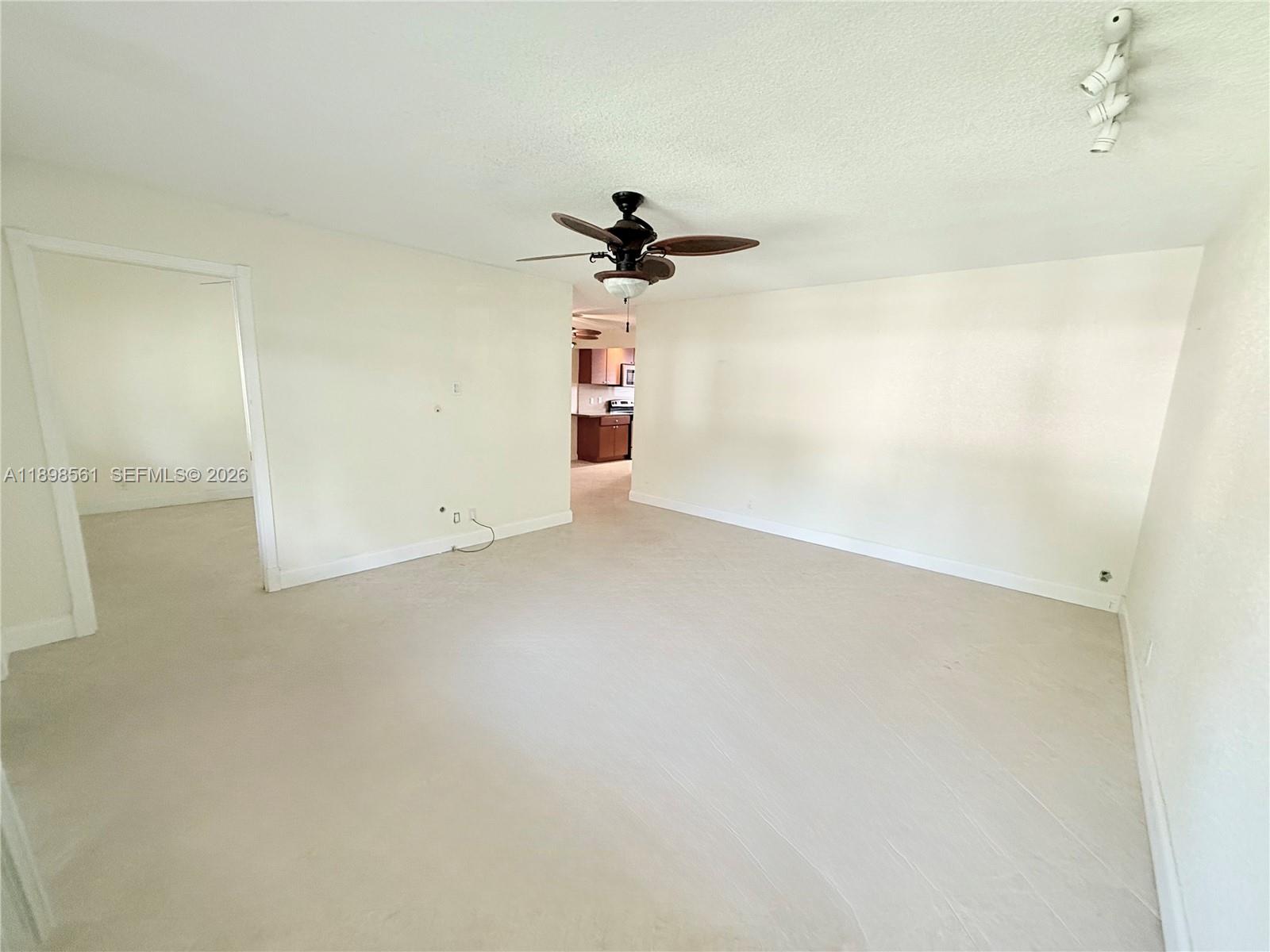 3600 Harrison Street, Unit 16B Hollywood, FL 33021 - Photo 5 of 34 an empty room with a fan and a ceiling fan