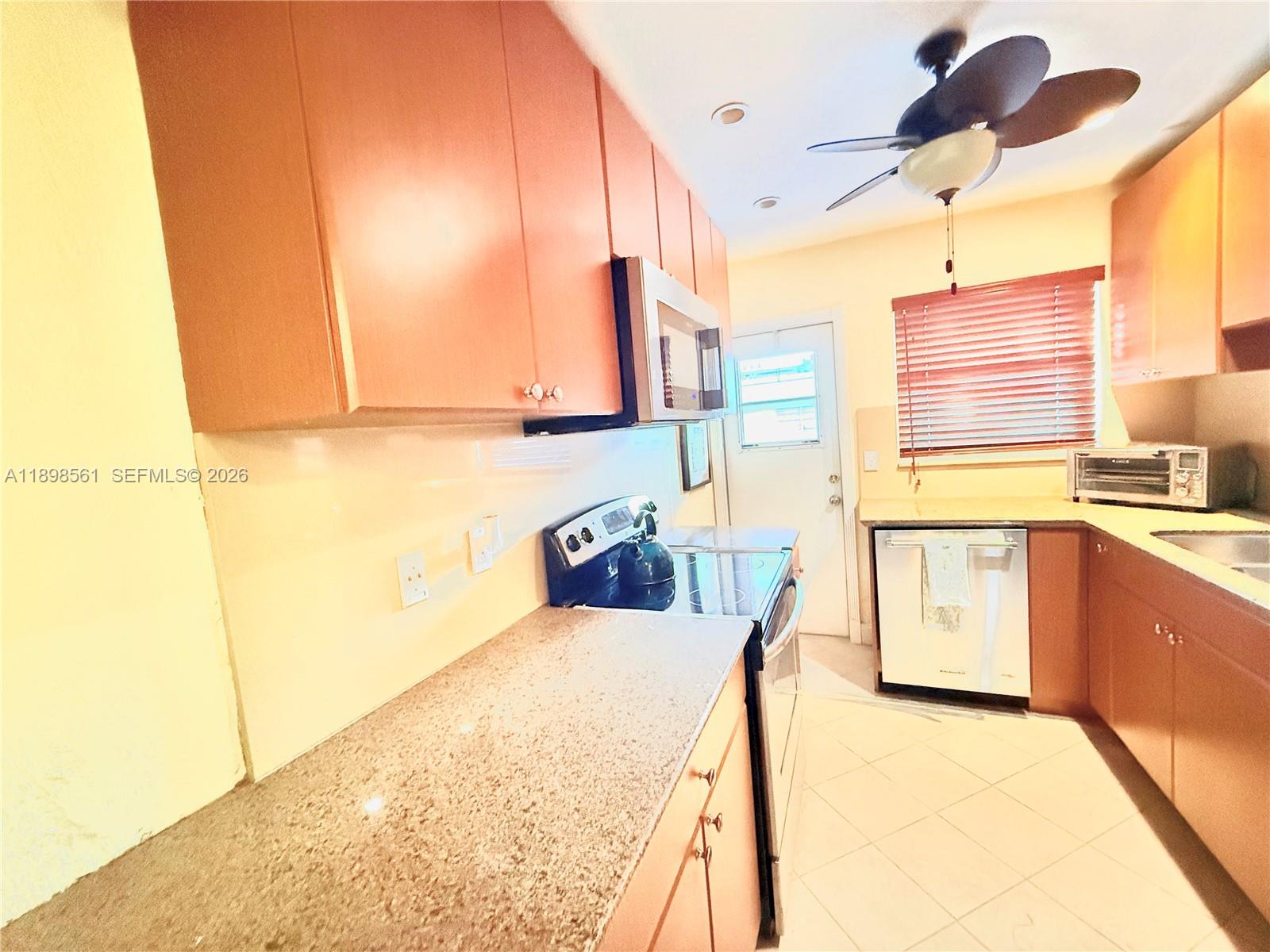 3600 Harrison Street, Unit 16B Hollywood, FL 33021 - Photo 7 of 34 a kitchen with stainless steel appliances kitchen island granite countertop a sink and cabinets