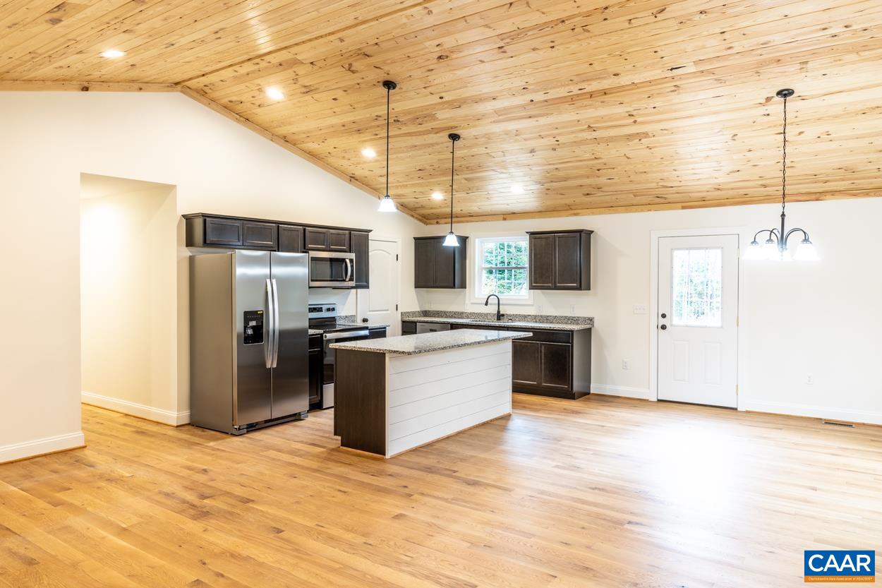 258 Twymans Mill Road Radiant, VA 22732 - Photo 17 of 59 a kitchen with stainless steel appliances kitchen island granite countertop a refrigerator and a stove top oven