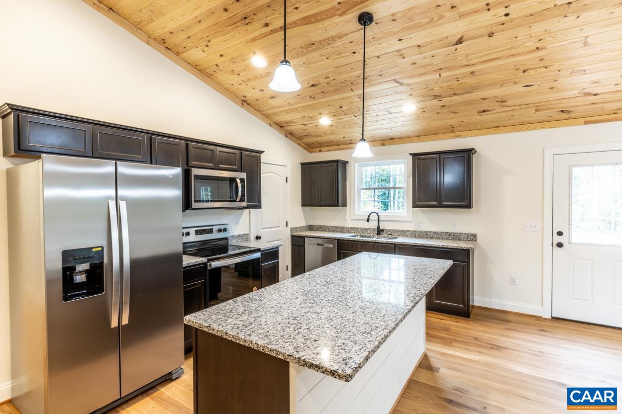 258 Twymans Mill Road Radiant, VA 22732 - Photo 20 of 59 a kitchen with stainless steel appliances granite countertop a sink a microwave oven and refrigerator