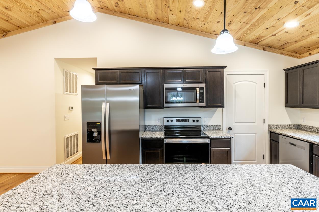258 Twymans Mill Road Radiant, VA 22732 - Photo 21 of 59 a kitchen with stainless steel appliances granite countertop a refrigerator a stove a sink a microwave oven with white cabinets and wooden floor