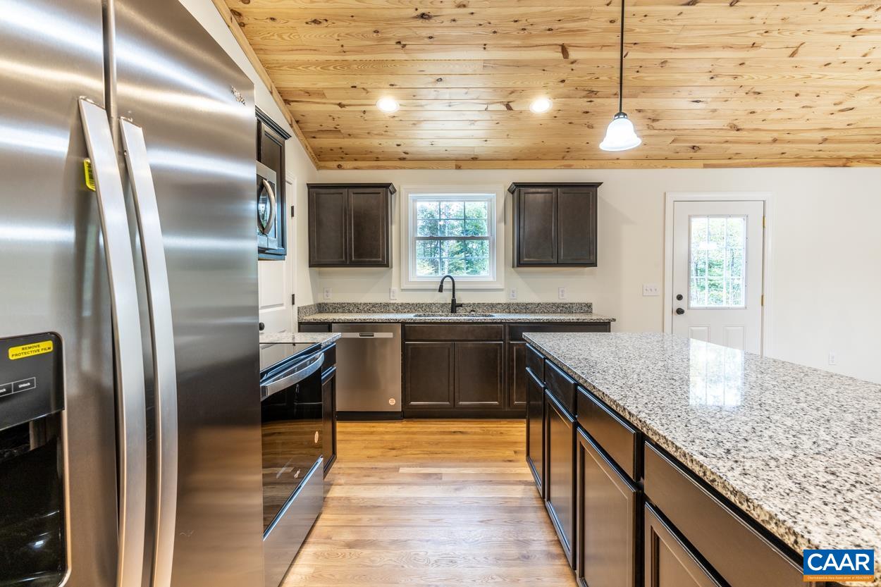 258 Twymans Mill Road Radiant, VA 22732 - Photo 23 of 59 a large kitchen with stainless steel appliances granite countertop a sink and a refrigerator