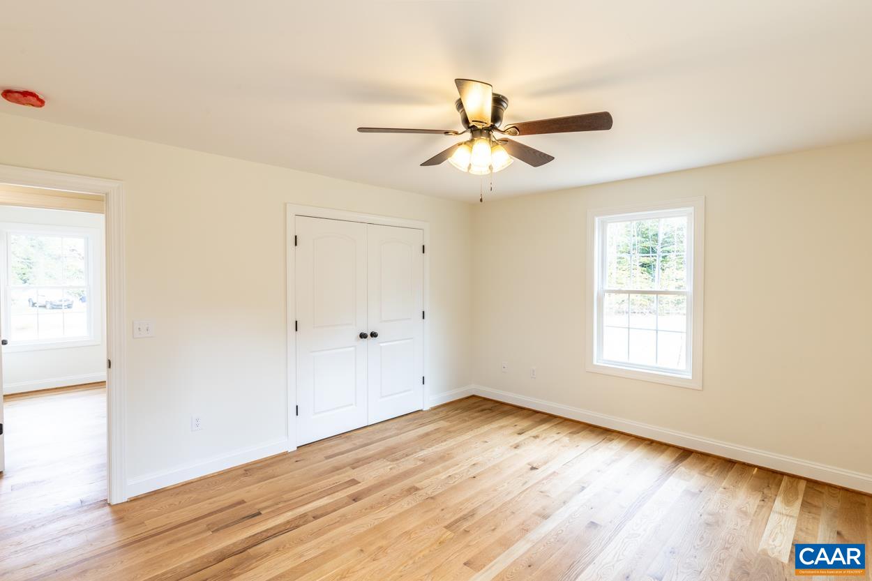 258 Twymans Mill Road Radiant, VA 22732 - Photo 29 of 59 an empty room with wooden floor fan and windows