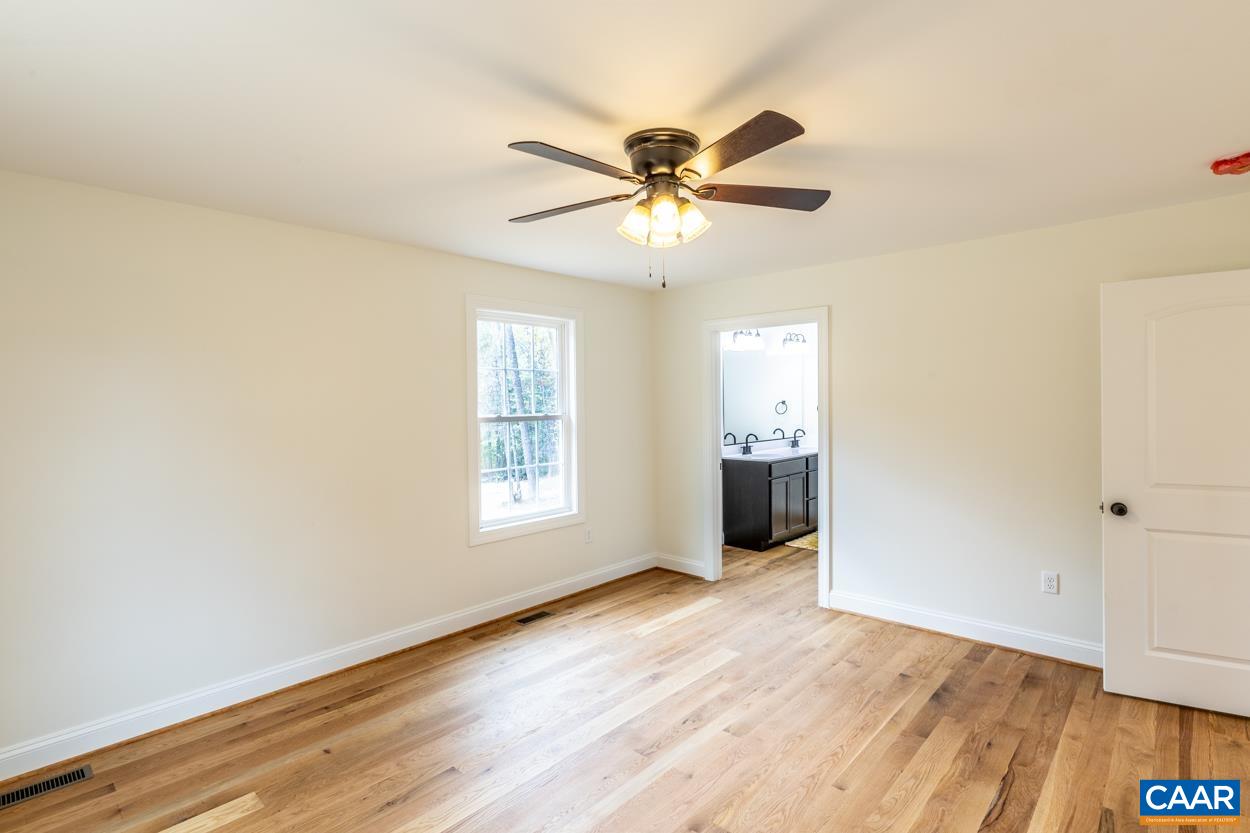 258 Twymans Mill Road Radiant, VA 22732 - Photo 31 of 59 a view of an empty room with wooden floor and a window