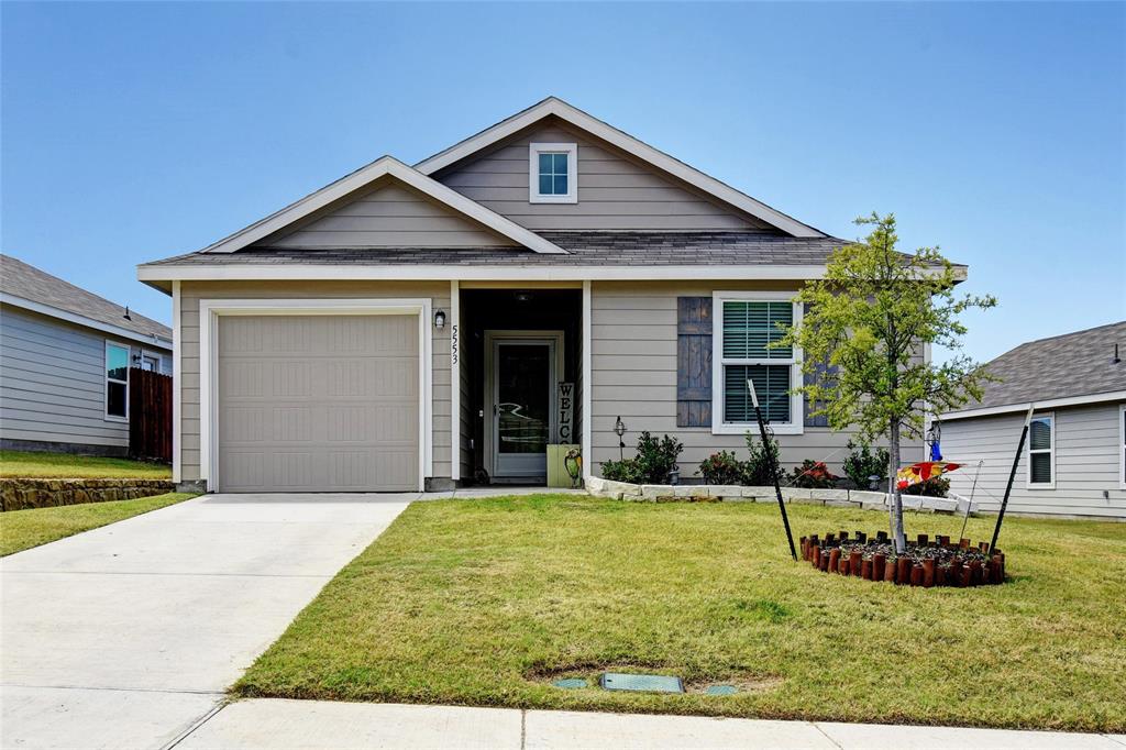 a front view of a house with yard and green space