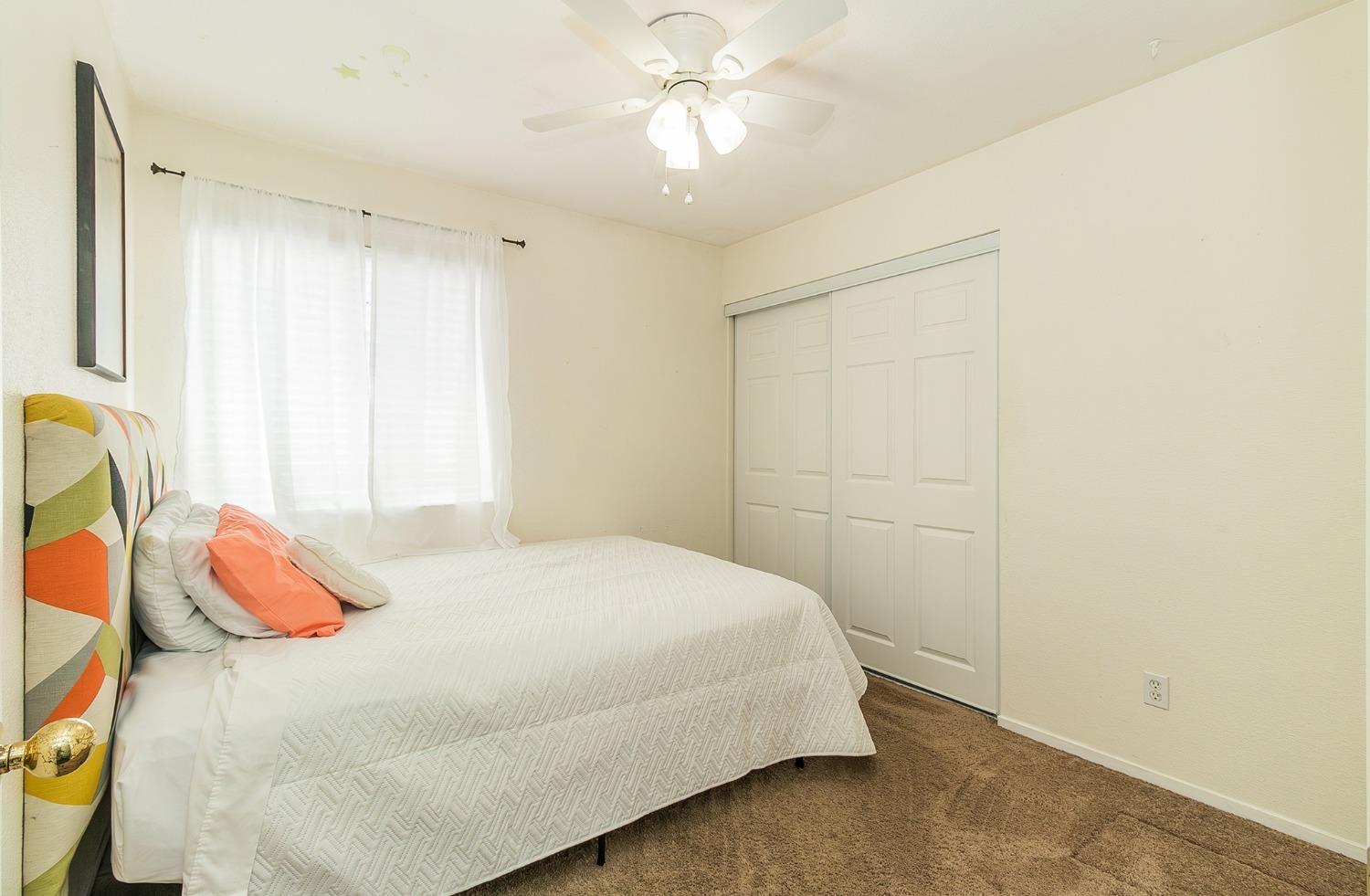 2831 Purvis Avenue Clovis, CA 93611 - Photo 18 of 26 a bedroom with a bed and a chandelier