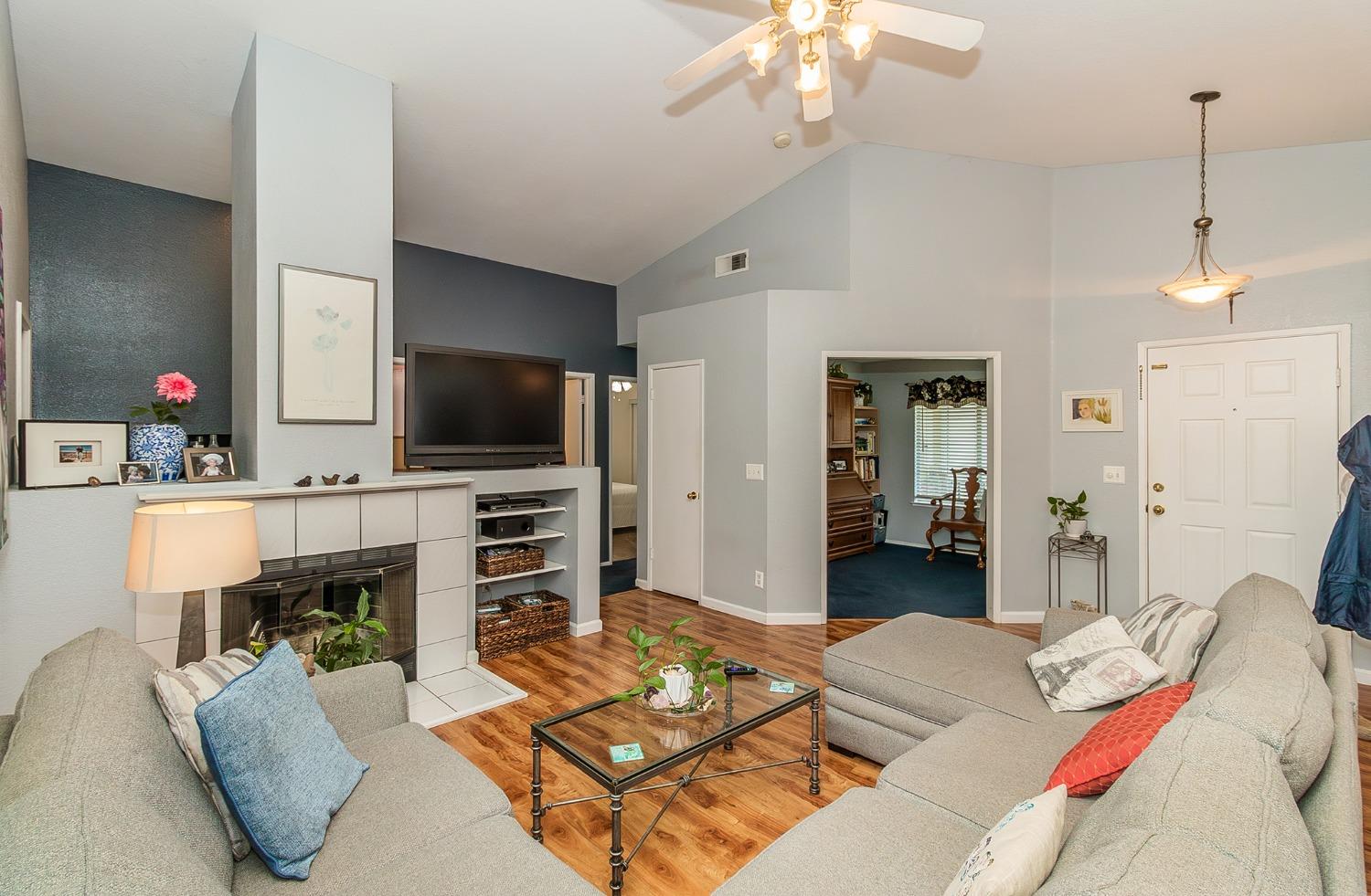 2831 Purvis Avenue Clovis, CA 93611 - Photo 4 of 26 a living room with furniture a flat screen tv and a fireplace