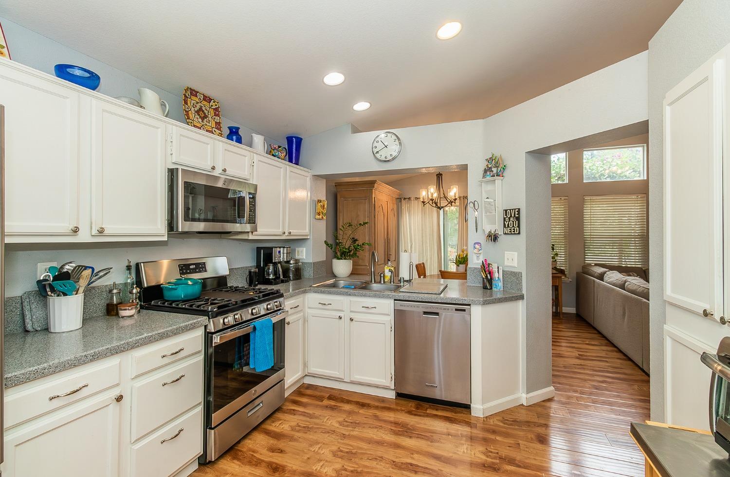 2831 Purvis Avenue Clovis, CA 93611 - Photo 10 of 26 a kitchen with stainless steel appliances kitchen island granite countertop a stove and a sink