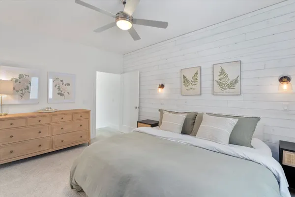 a bedroom with a large bed and a chandelier