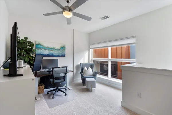 a living room with furniture a window and a chandelier