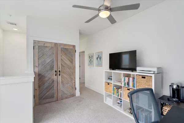 a view of a livingroom with furniture and a flat screen tv