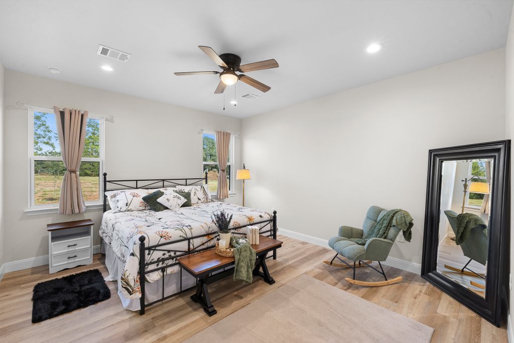 Gleaming wood floors and recessed lighting enhance this​​‌​​​​‌​​‌‌​‌‌​​‌​​​​‌​​​‌‌​‌‌‌ bedroom.