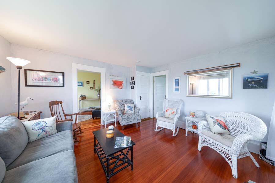 139 Shore Road Truro, MA 02666 - Photo 14 of 30 a living room with furniture a wooden floor and next to a window