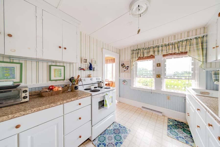 139 Shore Road Truro, MA 02666 - Photo 21 of 30 a open kitchen with granite countertop a sink stove and cabinets