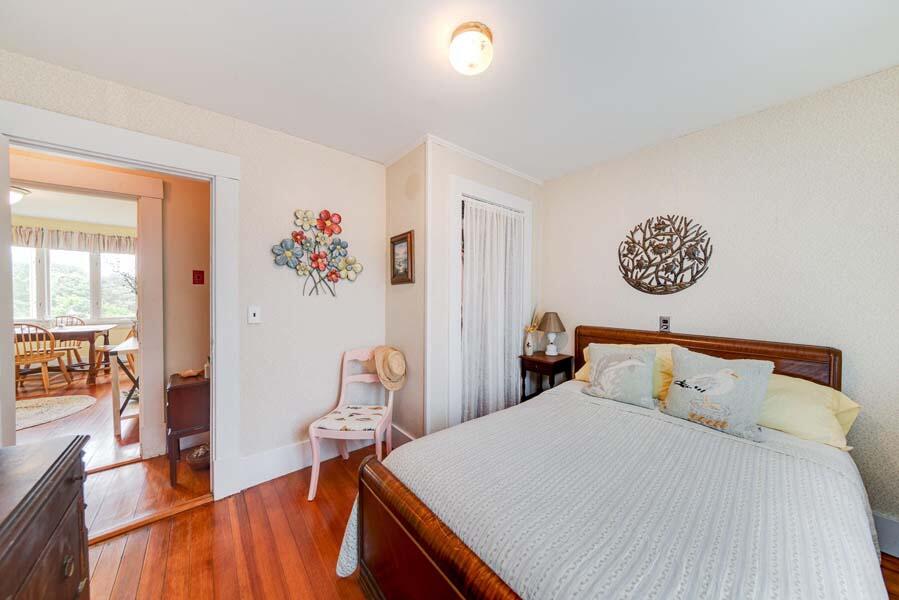 139 Shore Road Truro, MA 02666 - Photo 24 of 30 a bedroom with a bed and wooden floor