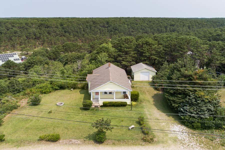 139 Shore Road Truro, MA 02666 - Photo 5 of 30 a view of a house with a yard