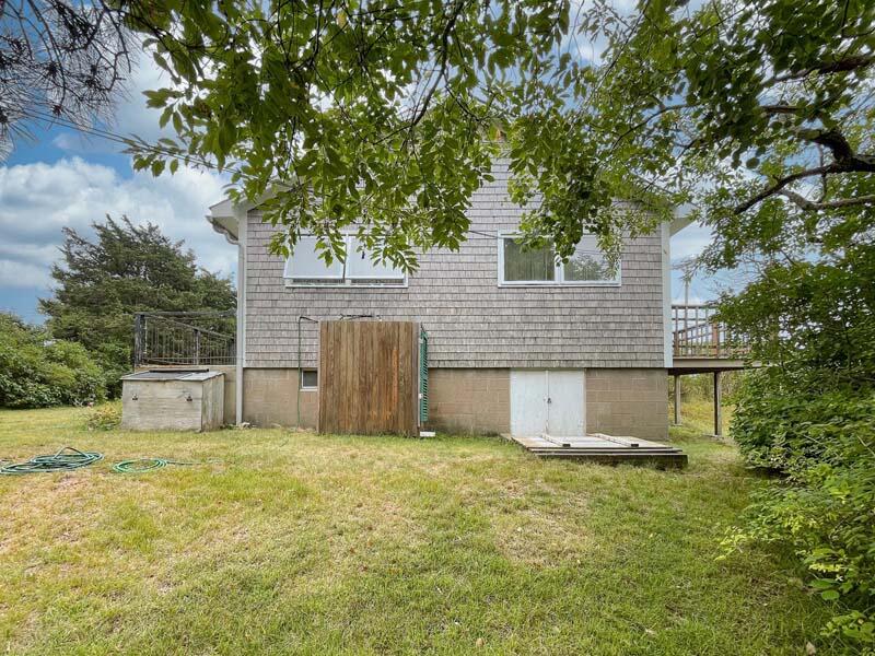 139 Shore Road Truro, MA 02666 - Photo 8 of 30 a view of a house with a yard