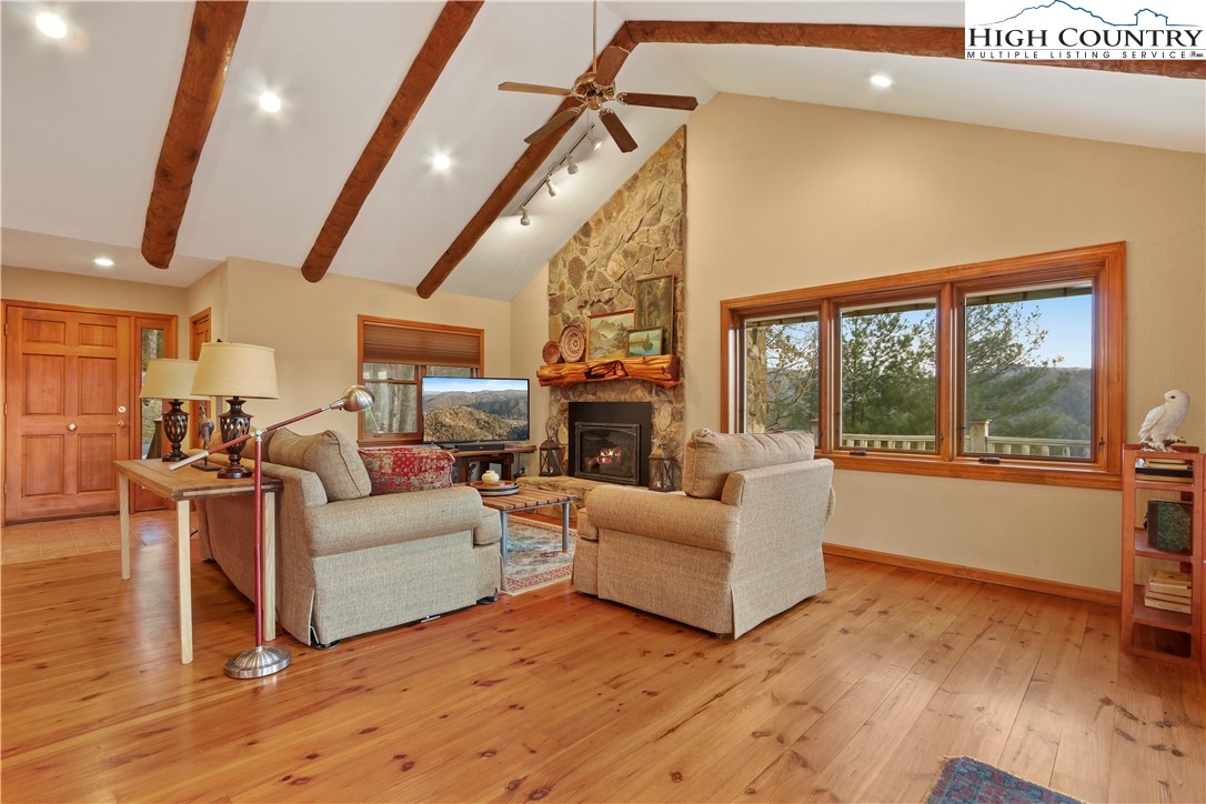 208 Granny's Ridge Road Ferguson, NC 28624 - Photo 5 of 37 a living room with furniture large window and a fireplace