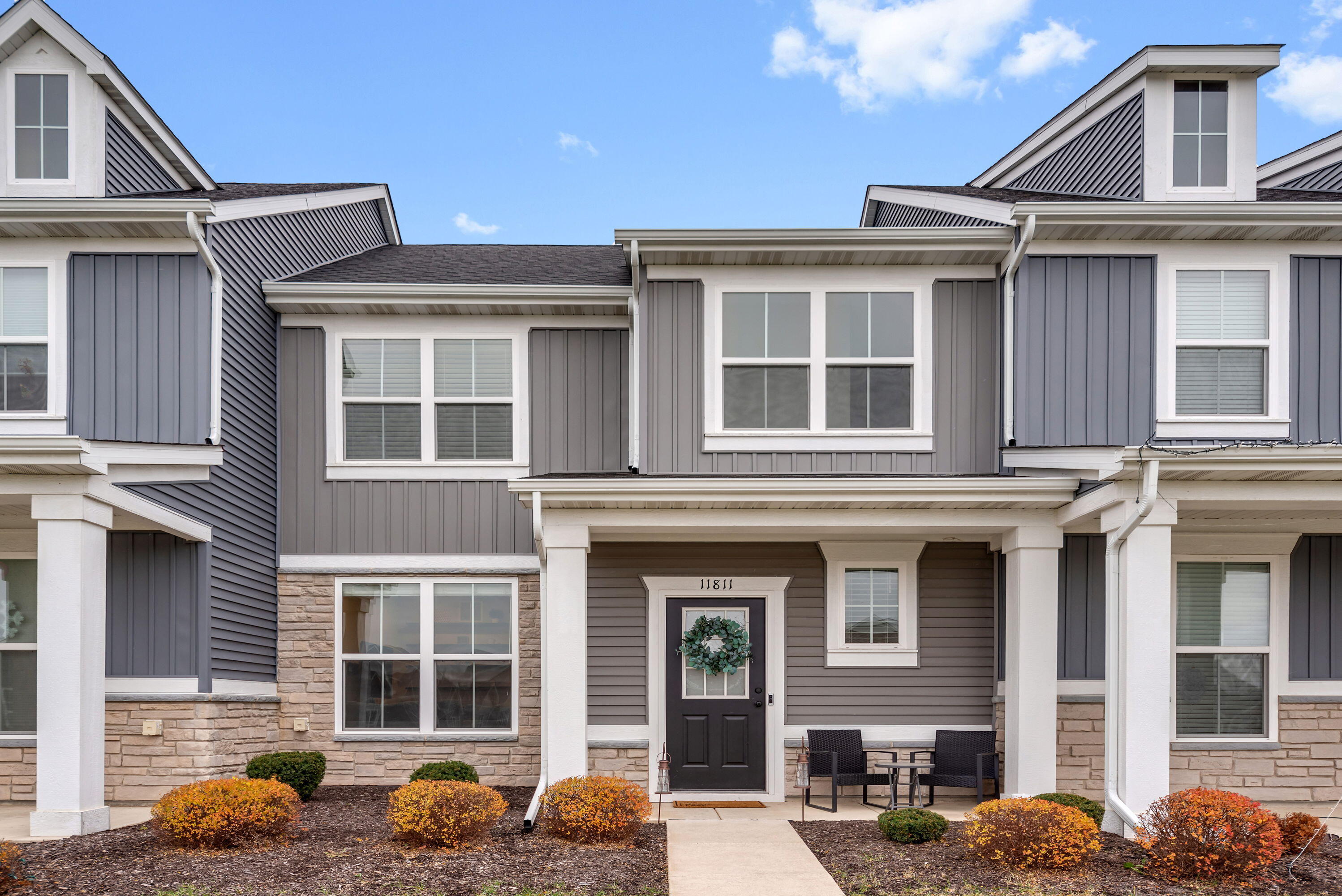 a front view of a residential apartment building with a yard