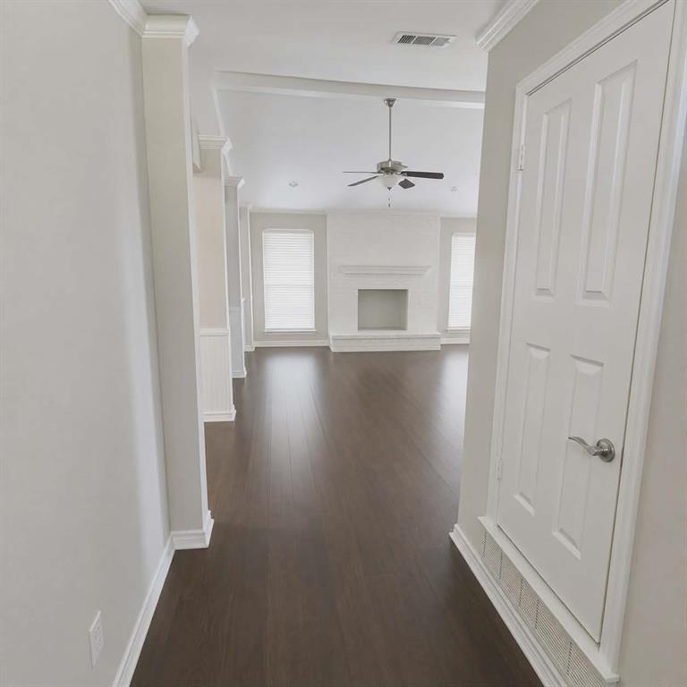 14752 Ranch Road Forney, TX 75126 - Photo 6 of 40 Spacious interior with dark wood-finish flooring, white baseboards, and crown molding- This photo was taken before family moved in