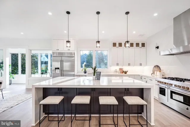 a large kitchen with a table and chairs