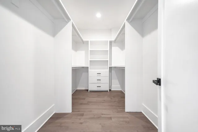 wooden floor with white walls and window
