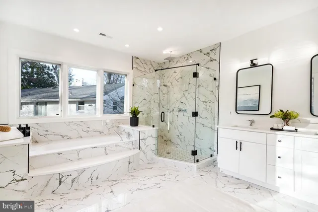 a large bathroom with a tub sink and mirror