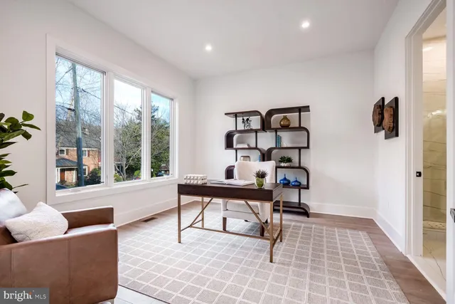 a living room with furniture and a floor to ceiling window