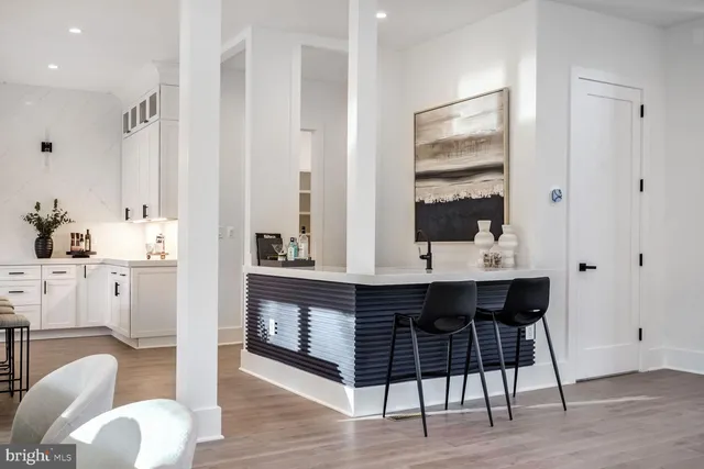 a view of living room with furniture and wooden floor